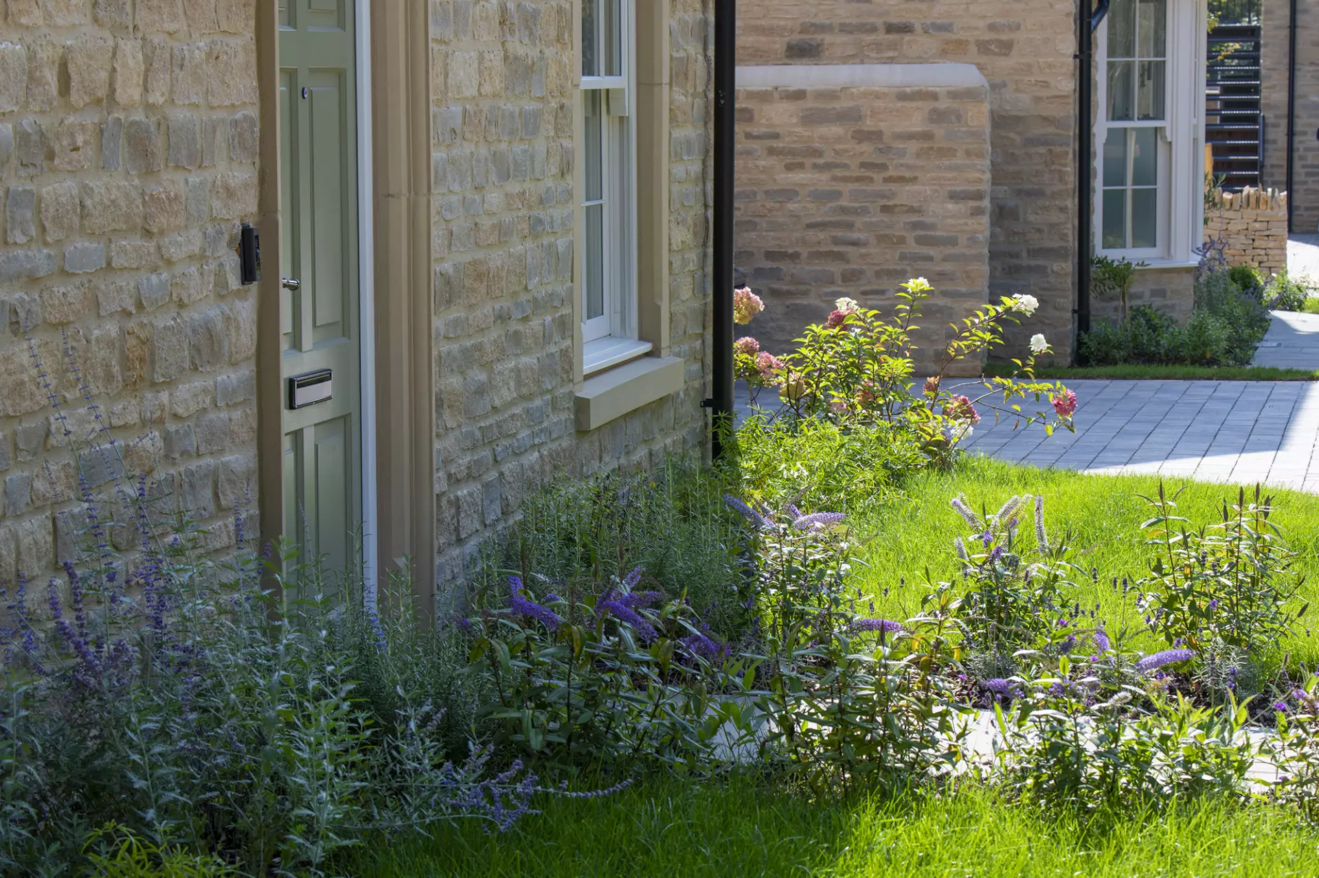 Stone and brick homes with a planted front garden
